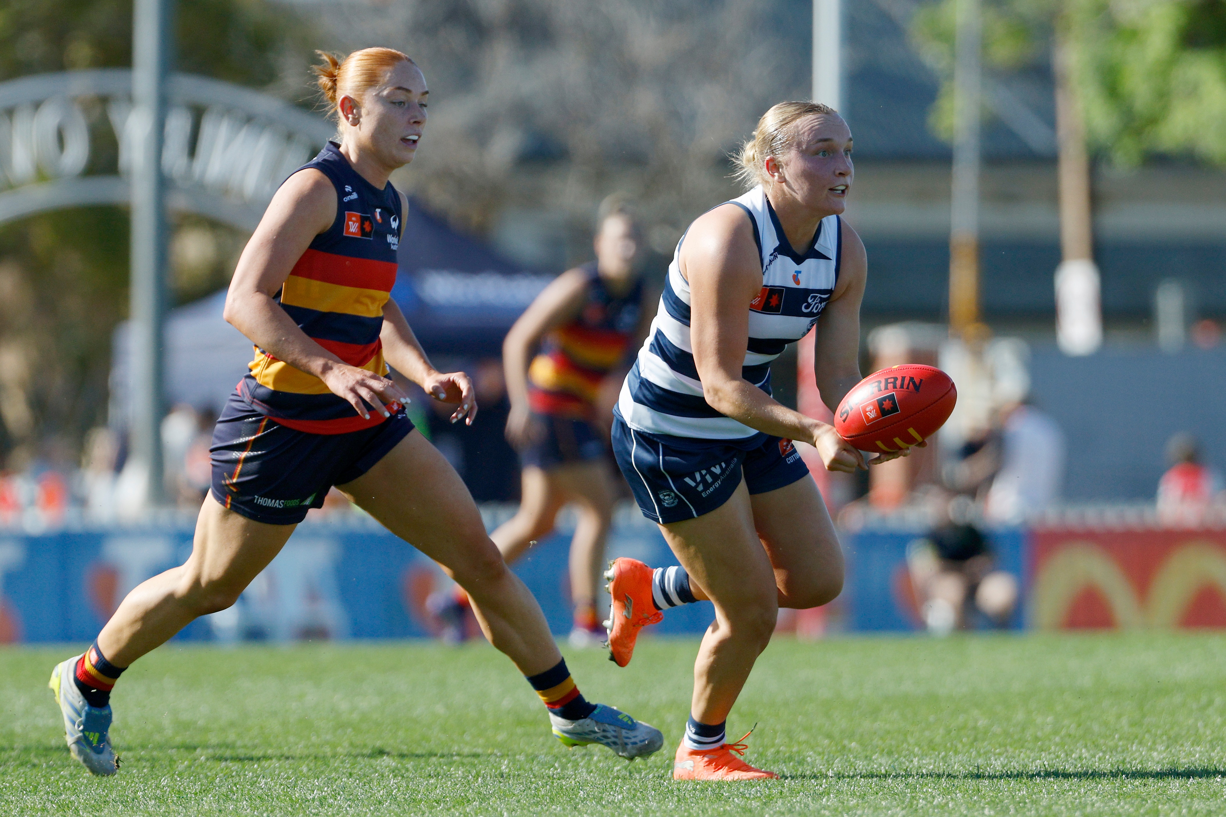 Zali Friswell handballs under pressure from Grace Egan