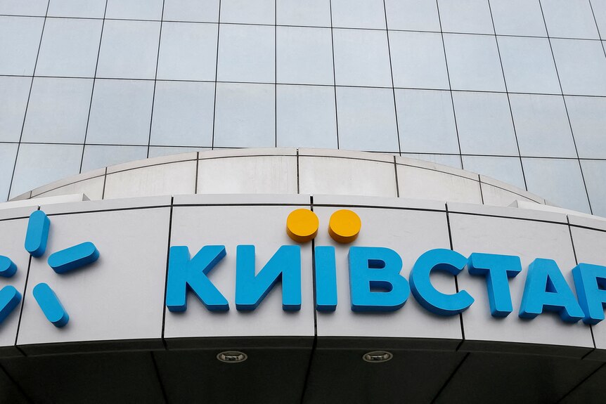 logo of kyivstar, written in cyrillic in blue with yellow dots