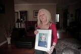 Carolyn Loughton with a photograph of her daughter, Sarah Loughton