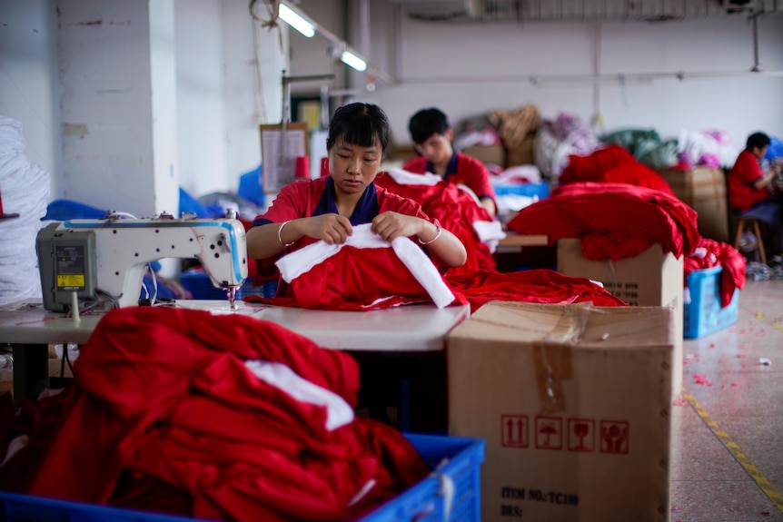Factory workers make Santa costumes in China.