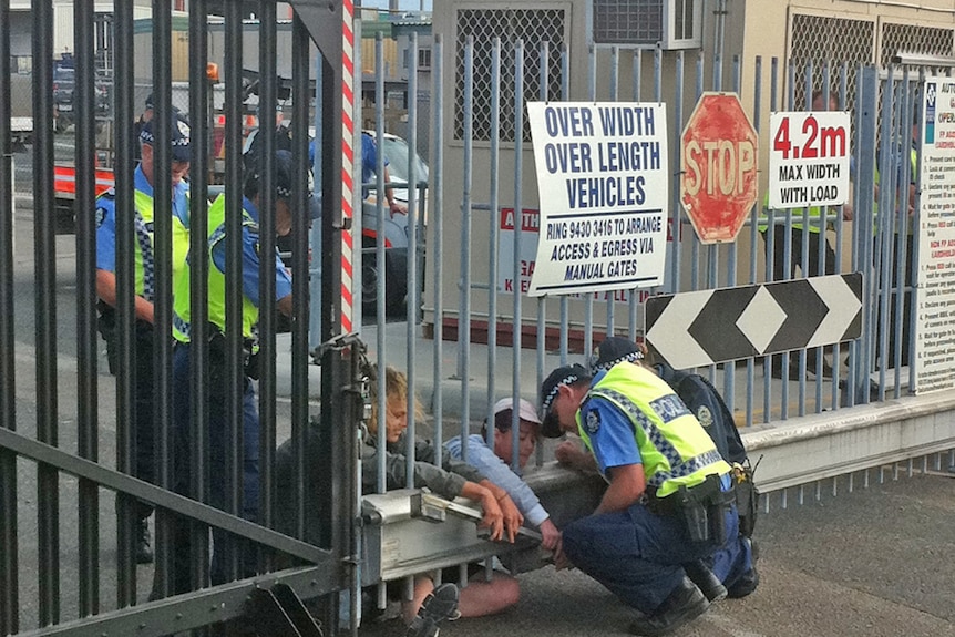 The protesters are chained to the gate