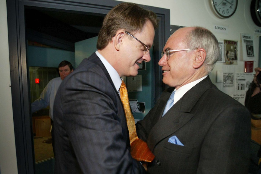 Mark Latham shakes John Howard's hand outside the ABC Radio studios in Sydney on October 8, 2004.