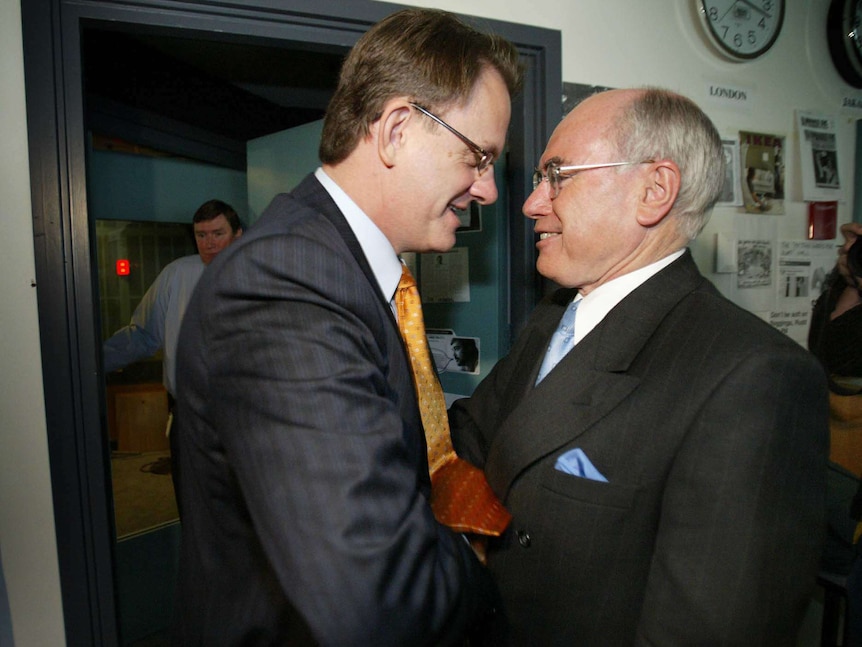 Mark Latham shakes John Howard's hand outside the ABC Radio studios in Sydney on October 8, 2004.