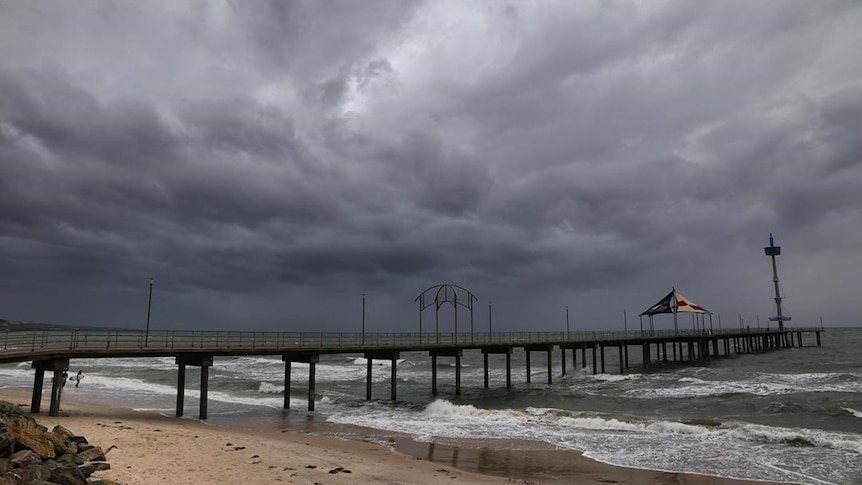 Dark grey clouds in the sky above Brighton jetty