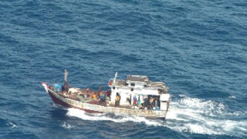 A boat carries suspected asylum seekers off Christmas Island