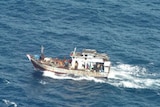 A boat carries suspected asylum seekers off Christmas Island