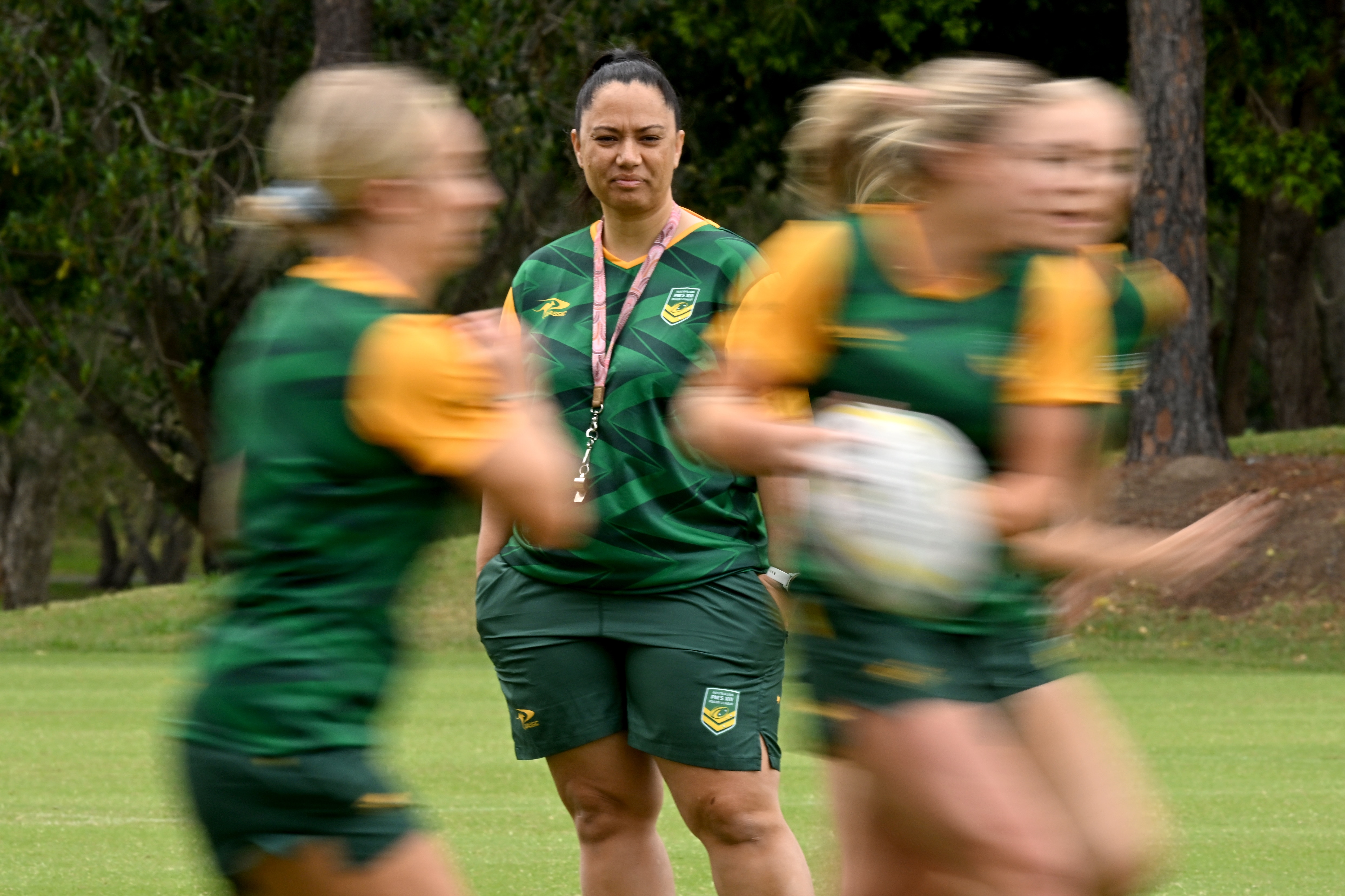A woman watches other women training