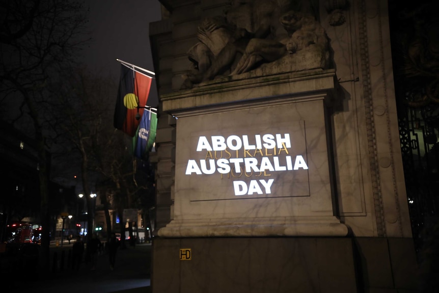 The words "Abolish Australia Day" projected onto a monument in London.