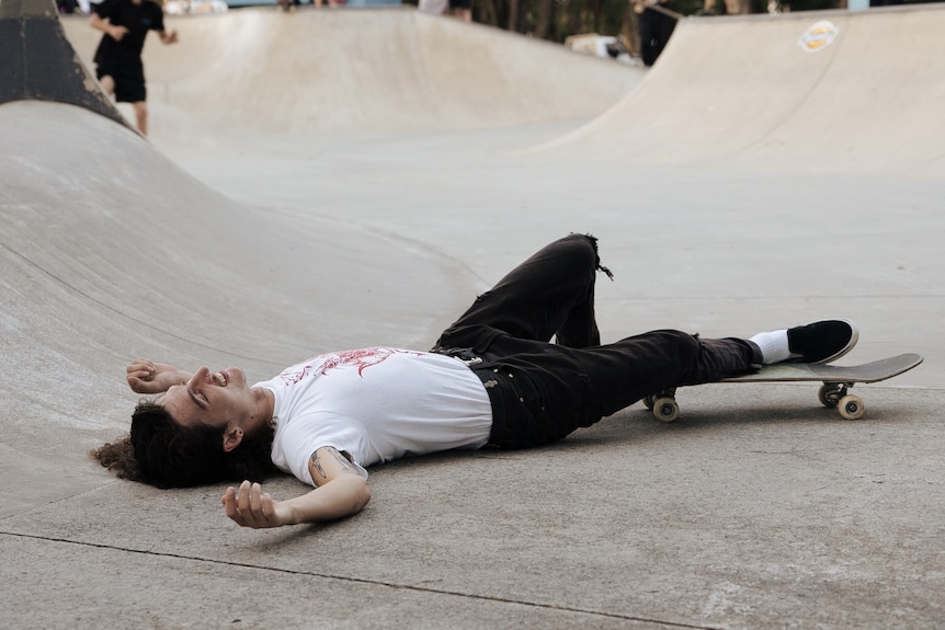 skater lying down on concrete