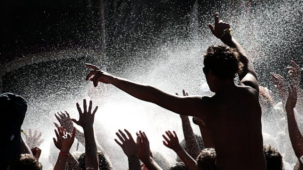 Concert goers enjoy a spray of water.