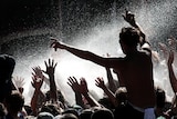 Concert goers enjoy a spray of water.