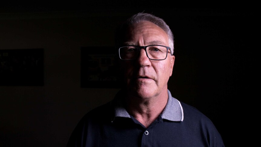 Deputy Mayor of Lithgow, Wayne McAndrew, stands in a dark room