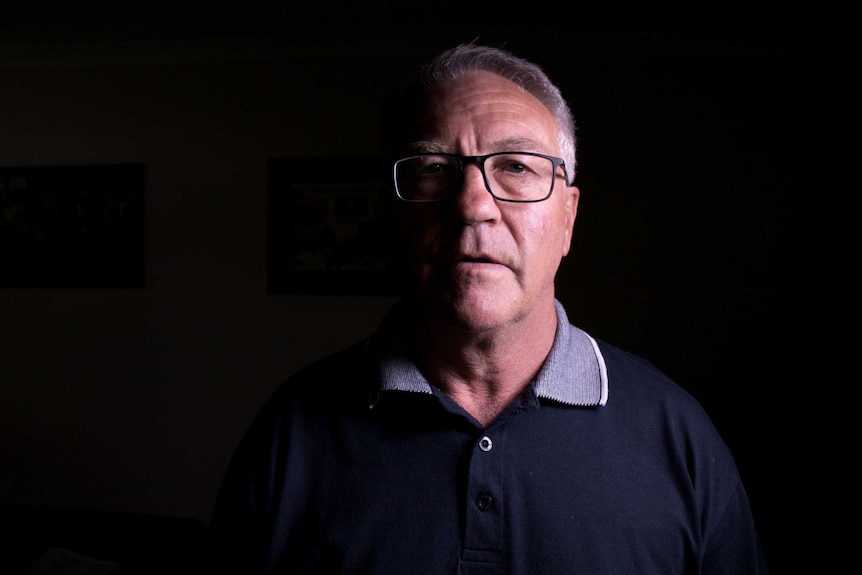 Deputy Mayor of Lithgow, Wayne McAndrew, stands in a dark room