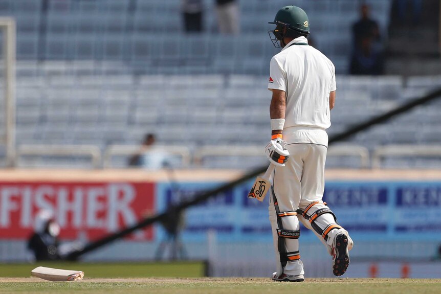 Glenn Maxwell carries a broken bat after a delivery from India's Umesh Yadav