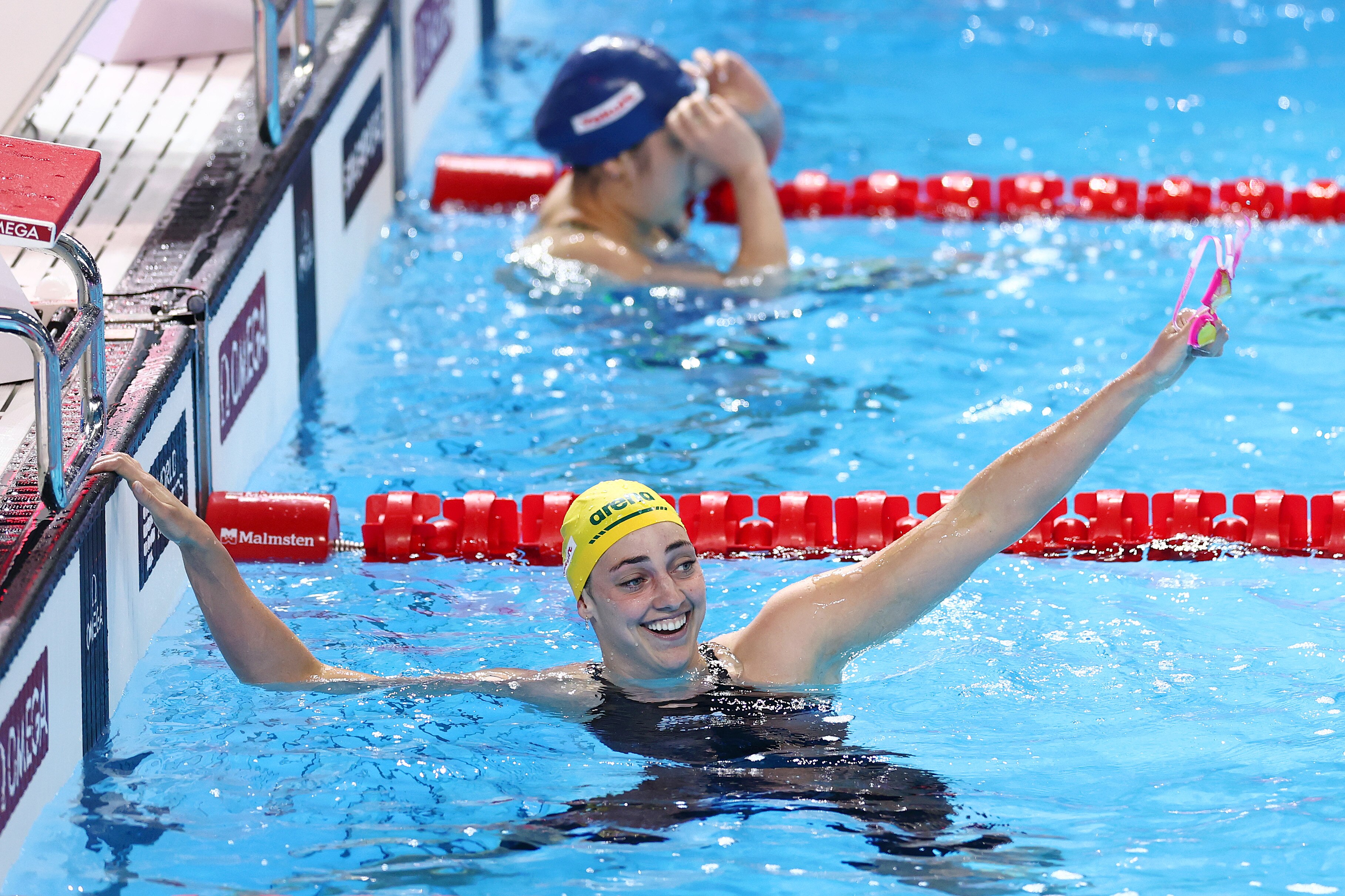 Meg Harris celebrates inside the swimming pool
