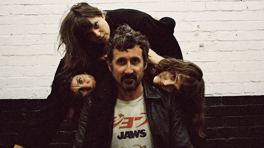 Members of Tropical Fuck Storm bunch up behind frontman Gareth Liddiard, who wears a Jaws t-shirt