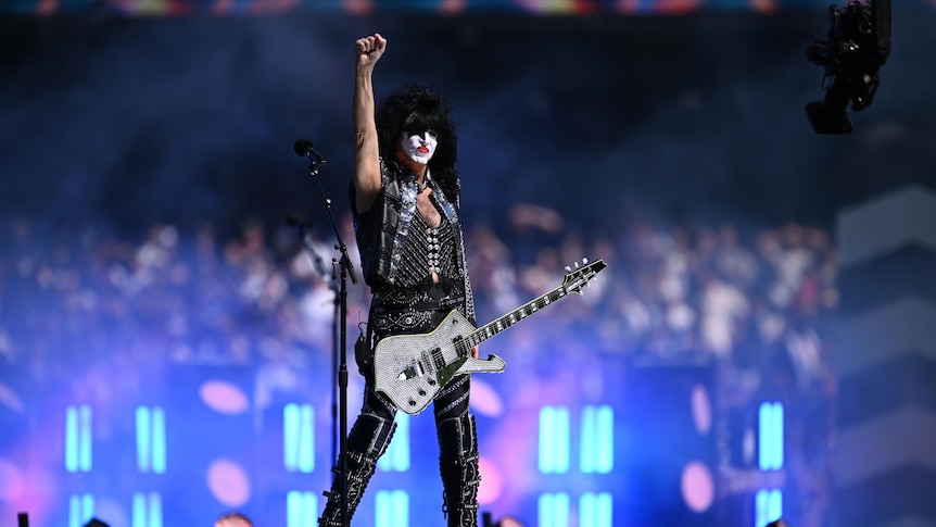 KISS member on stage, with his fist raised.