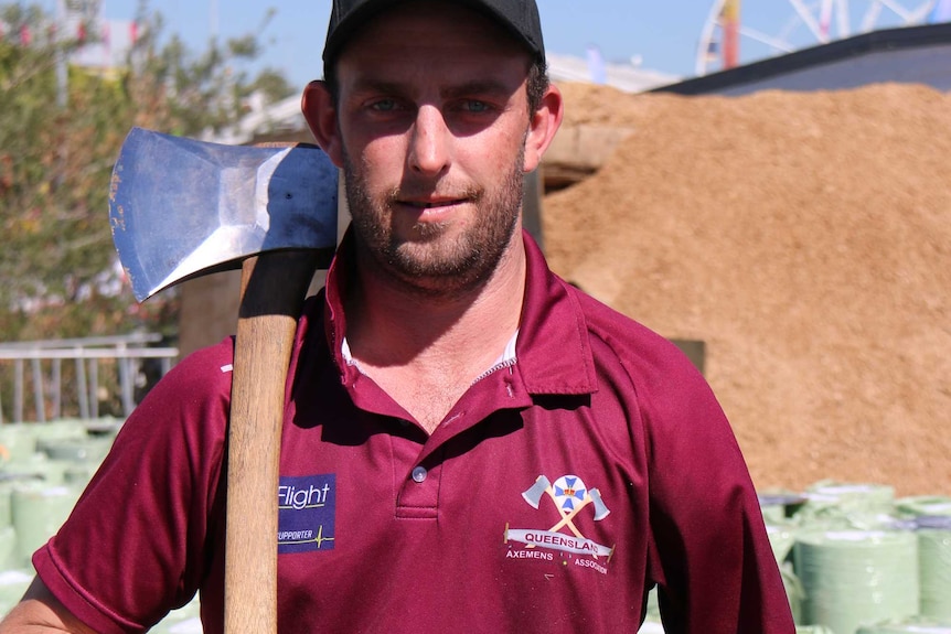 One-armed woodchopping competitor in Royal Queensland Show holds an axe.