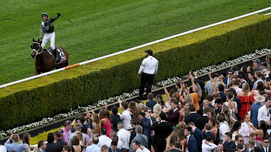 Glen Boss salutes to the crowd after winning at Randwick