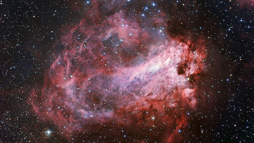 Star field with molecular gas and dust clouds in the foreground where new stars are being made