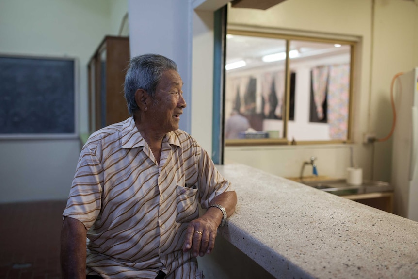 An elderly Chinese man enjoys a drink at the Poon Saan club on Christmas Island.