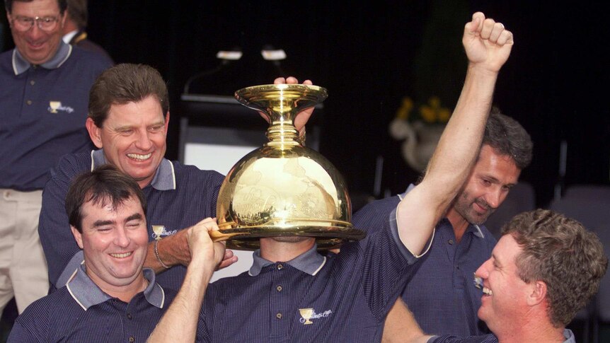 Stuart Appleby poses with the President's Cup trophy after the Internationals beat the US in 1998