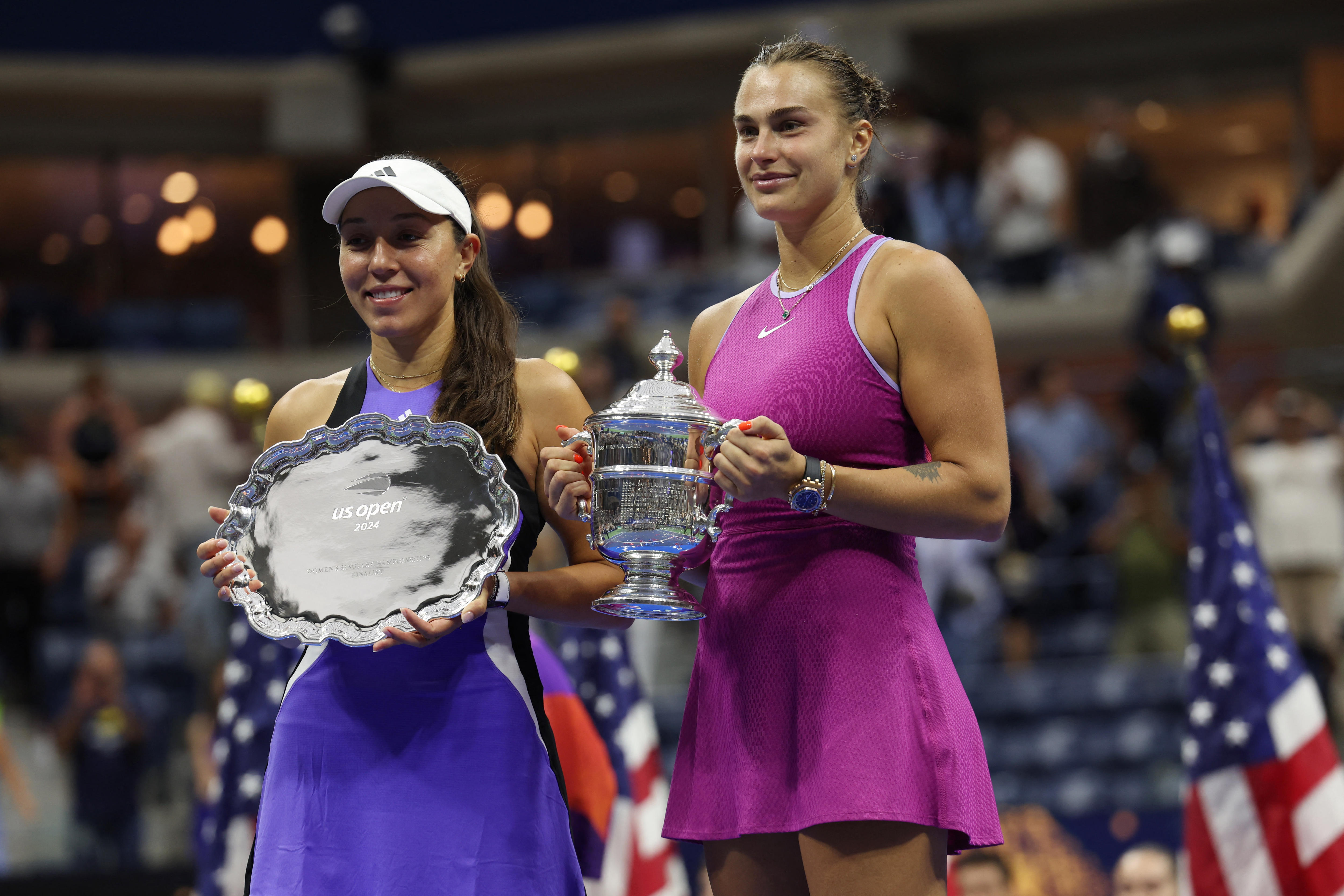 Finalists of a tennis tournament pose with the trophies at the end of the match