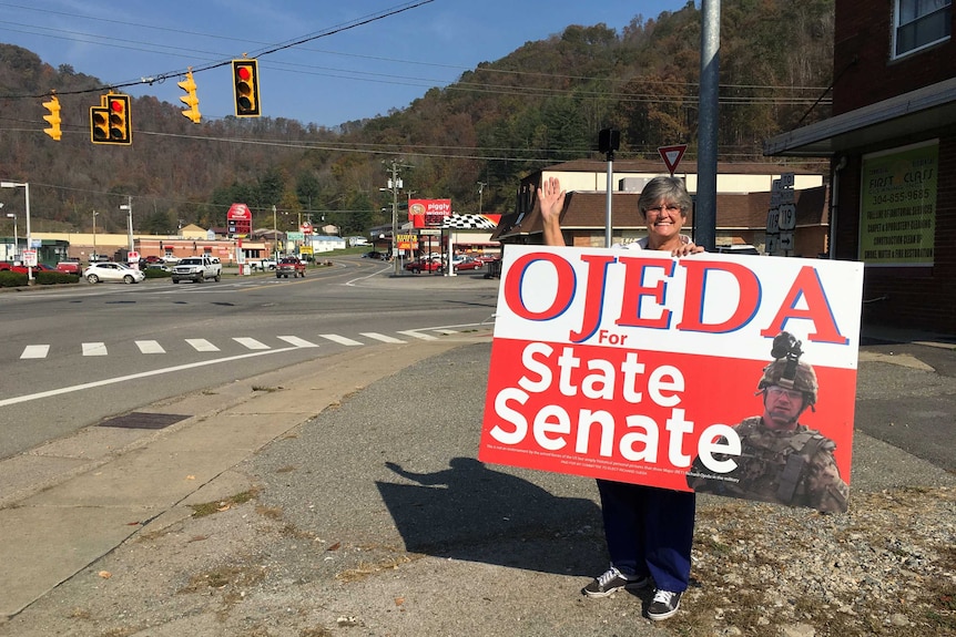 Logan County resident Betty Adams holds up a sign promoting Richard Ojeda for the State Senate.