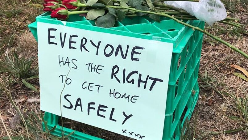 A milk crate is seen with the sign "Everyone has the right to get home safely" at the site Aiia Maasarwe's body was found.