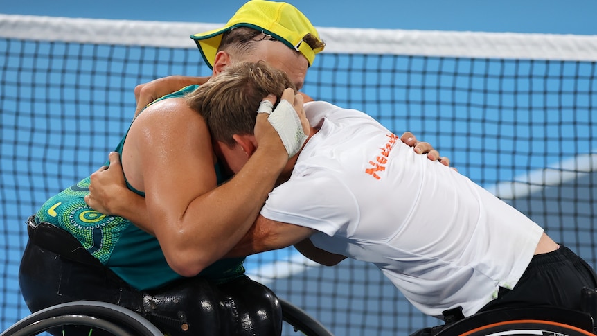 Australia's Dylan Alcott comforts distraught Dutch player Niels Vink after their wheelchair tennis semi-final in Tokyo. 