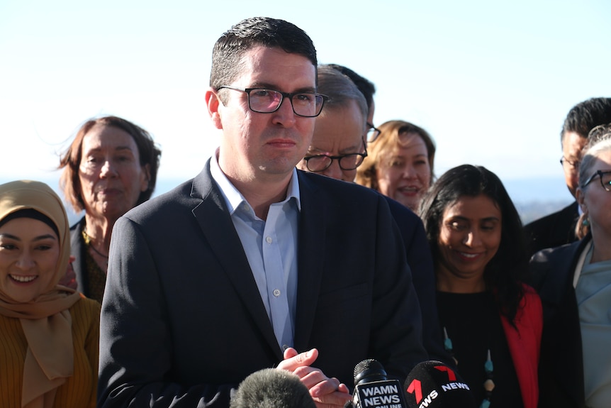 Patrick Gorman flanked by fellow Labor MPs.