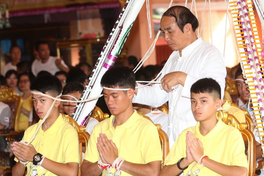 Members of Thai soccer team pray at a Buddhist ceremony