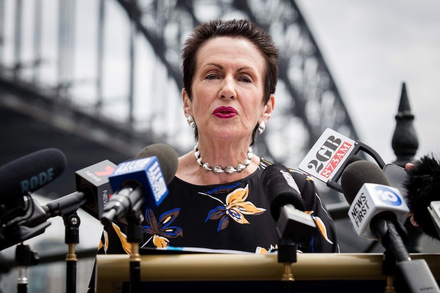 woman with short hair at a press conference