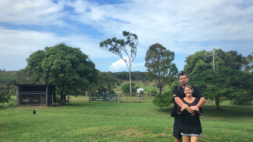 couple hugging on farmland