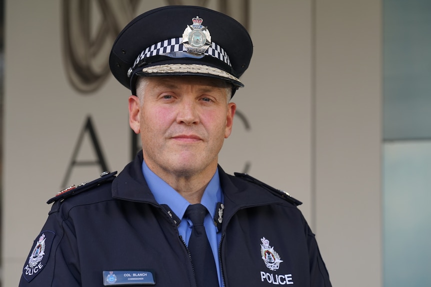 The WA Police Commissioner Col Blanch stands wearing his uniform outside a grey building