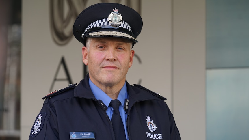 The WA Police Commissioner Col Blanch stands wearing his uniform outside a grey building