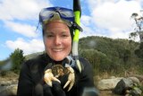 Mae Noble from The Australian National University's Fenner School of Environment and Society hold a Murray crayfish.