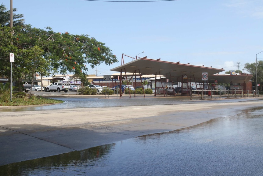 Ballina bus stop with some water on the street.