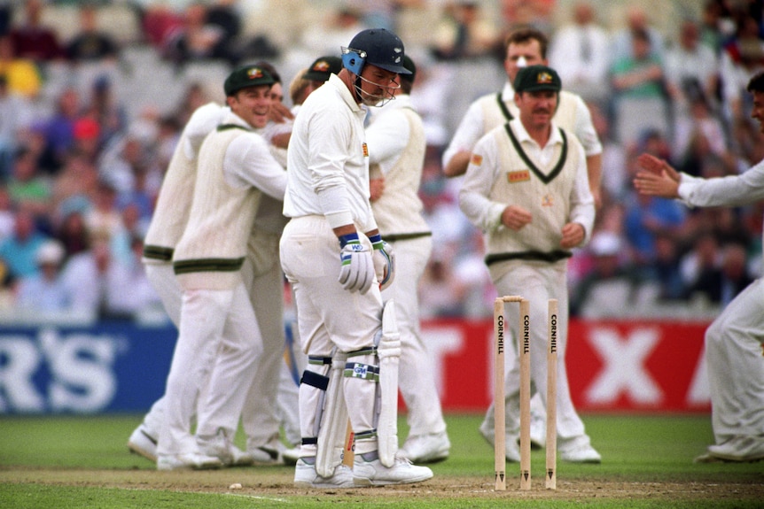England batter Mike Gatting looks confused as he looks at his stumps after being bowled by Shane Warne.