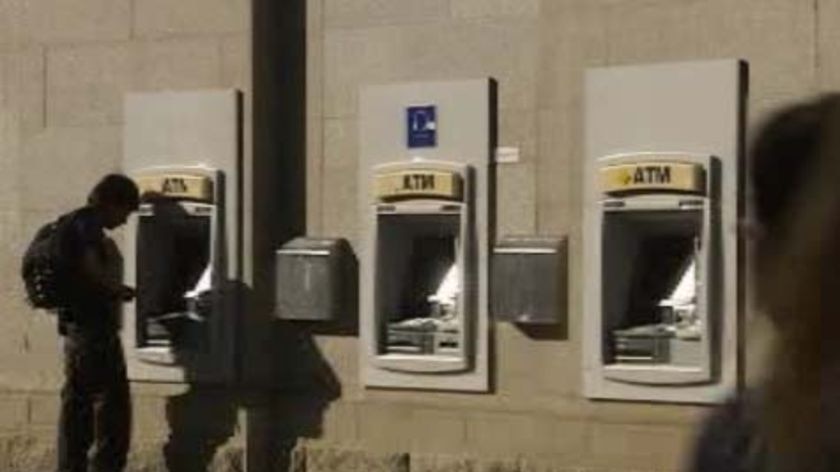 Man uses a Commonwealth Bank ATM