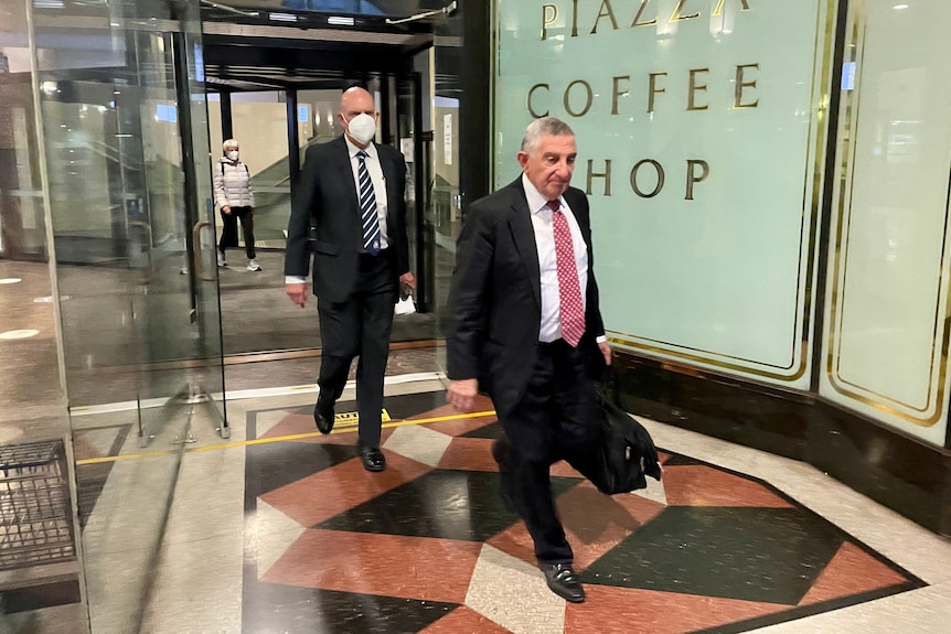 Two men leave court