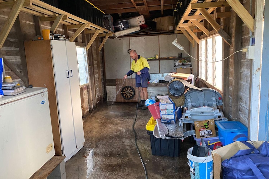 Roly Green cleaning out his shed at his property at Jacobs Well.