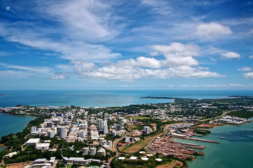 An aerial shot of Darwin harbour showing blue sky, clouds and buildings on the peninsula.