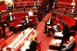 MPs wear mask in the red chamber of Parliament.