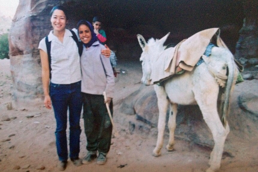 Kumi Taguchi in Jordan with a young local girl