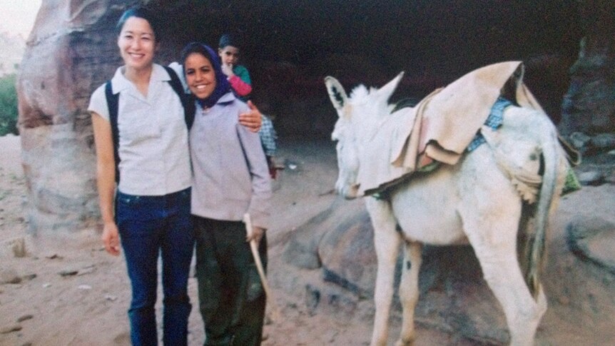 Kumi Taguchi in Jordan with a young local girl