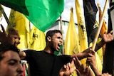 Palestinians wave Fatah and Hamas flags during ceasefire celebrations.