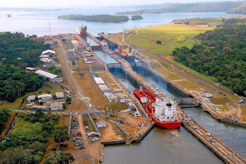 Ships pass through the Gatun locks of the Panama Canal