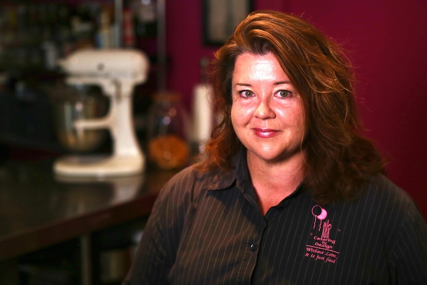 A woman with brown hair and a striped shirt.