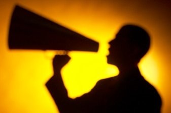 A man speaks through a megaphone. (Getty Images: Hemera Technologies)